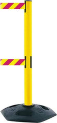 Tensator - 38" High, 2-1/2" Pole Diam, 4 Way Stanchion - 19" Base Diam, Octagon Recycled Rubber Base, Yellow Plastic Post, 7-1/2' x 2" Tape, Dual Line Tape, For Outdoor Use - Industrial Tool & Supply